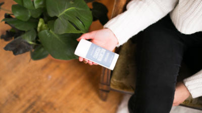 woman holding schmidt's charcoal and magnesium deodorant